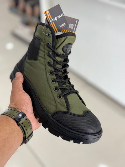 Front-side angle view of PROTAC RAPTOR Hunter 2.0 green and black boot held by a hand with brand tag visible