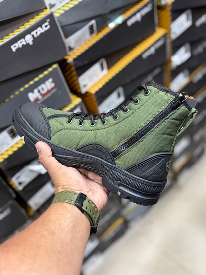 PROTAC RAPTOR Hunter 2.0 Green hiking boot with black sole held by a hand in front of shoe boxes