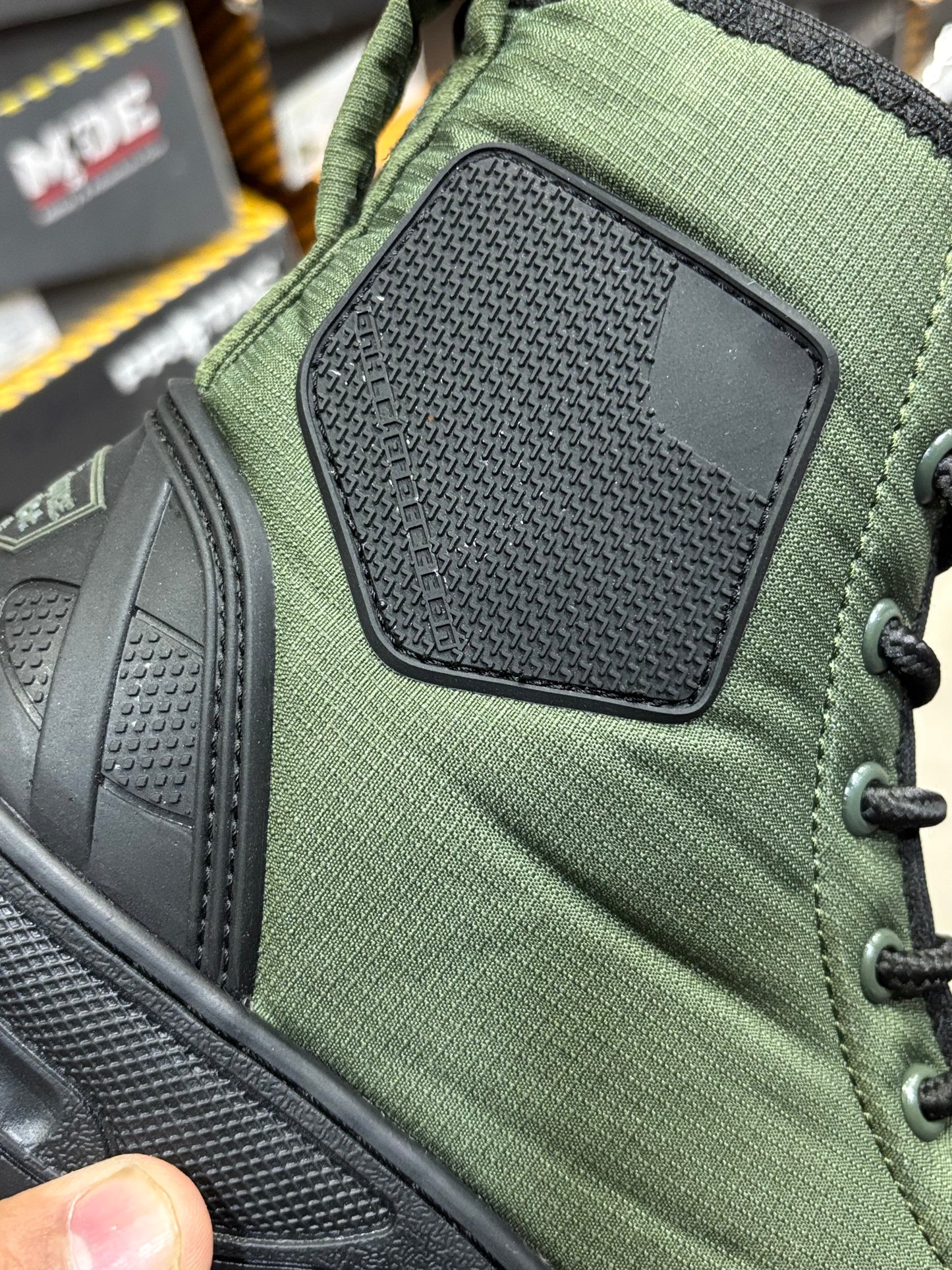 Close-up view of PROTAC RAPTOR Hunter 2.0 green boot with black side panel