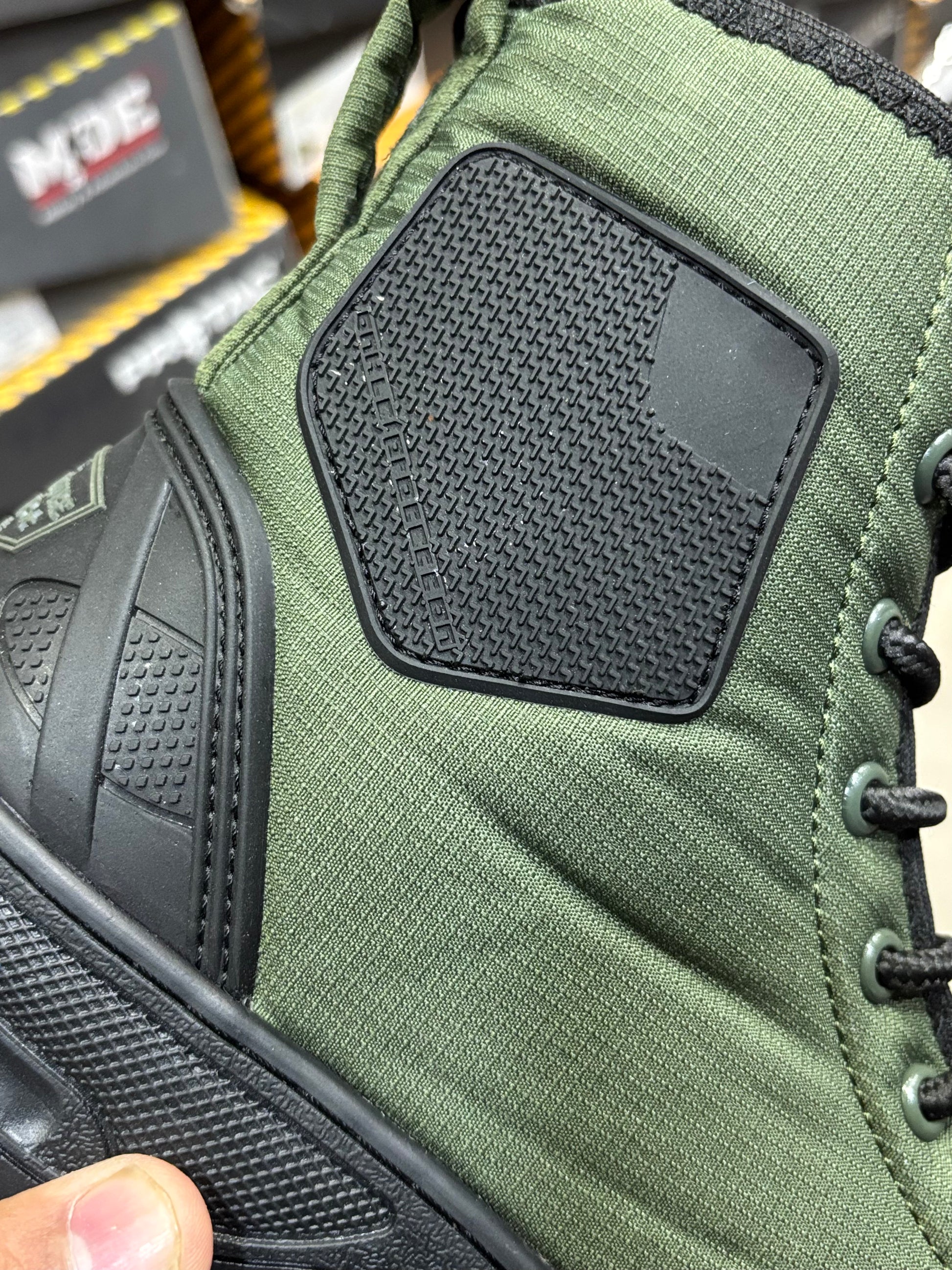 Close-up view of PROTAC RAPTOR Hunter 2.0 green boot with black side panel