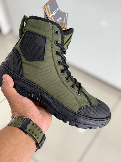 PROTAC RAPTOR Hunter 2.0 green high-top boot with black sole held by a hand, brand tag visible
